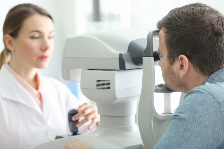 Female doctor examining adult male patient